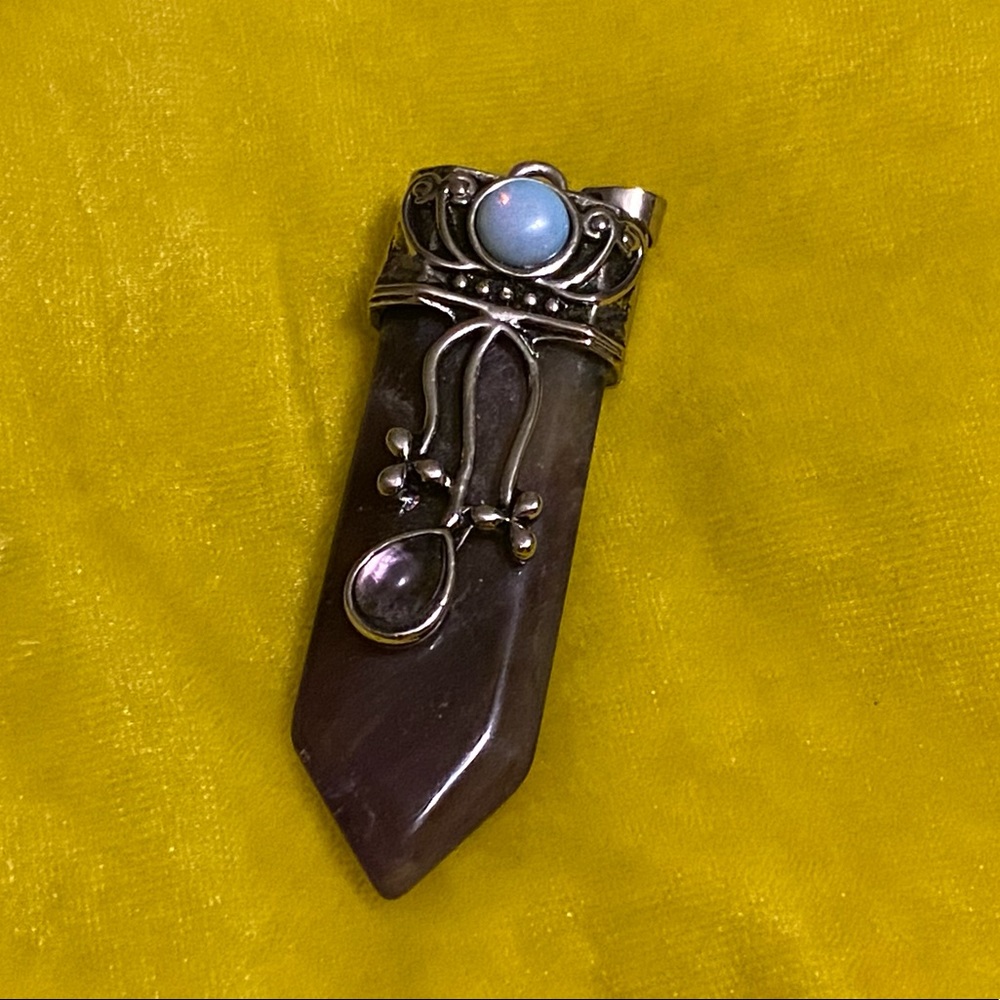 Amethyst pendant w/ opalite accent. HOLDING